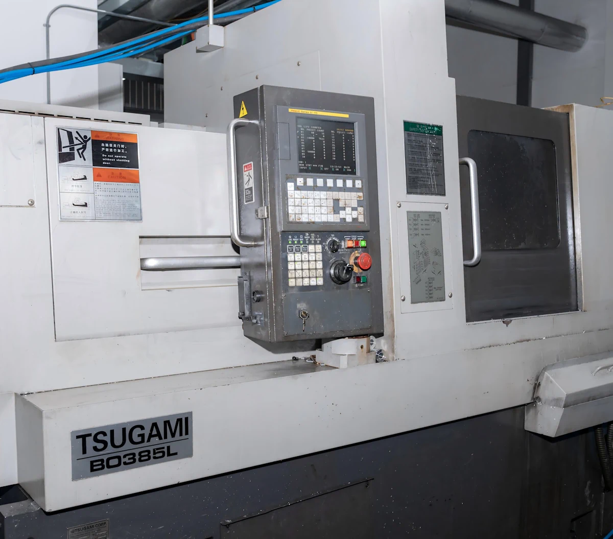 Tsugami Swiss-type lathe on the production floor for precision turning operations Tsugami Swiss-type lathe on the production floor for precision turning operations